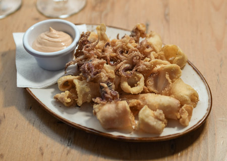 A serving of fried squid with garlic sauce in a European restaurant