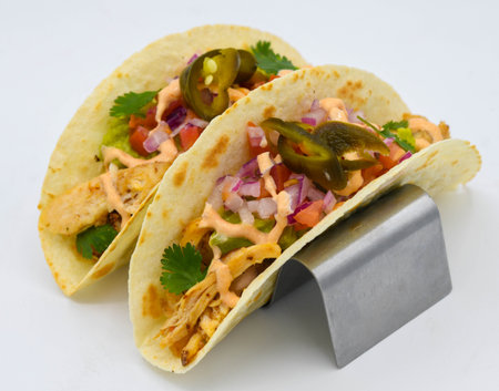 Mexican tacos with chicken and guacamole on white backgroundの写真素材