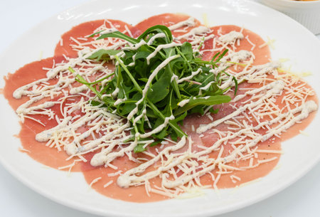 Meat carpaccio with arugula and parmesan cheeseの写真素材