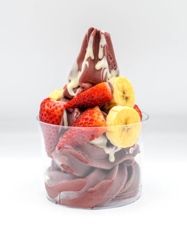 Yogurt and aÃ§ai ice cream with chopped fruit piecesの写真素材