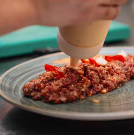 Beef tartare with chilli pepper and sesame seeds.の写真素材