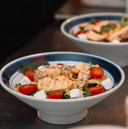 Salad with chicken, cherry tomatoes, Greek cheese and arugulaの写真素材