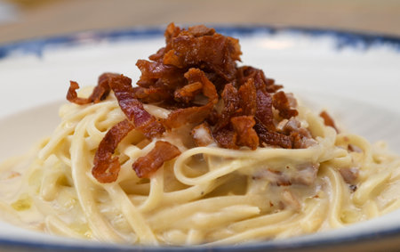 Spaghetti carbonara with bacon on a plate, close-upの写真素材