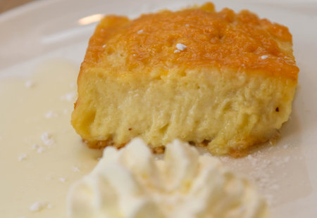 Cottage cheesecake served on a plate with whipped cream