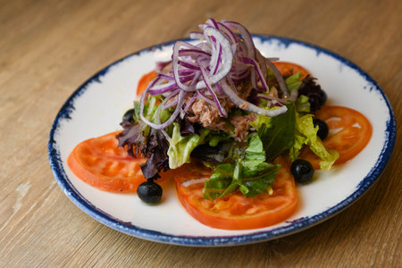 Salad with prickly pear, lettuce, red onion, black olives and tomatoの写真素材
