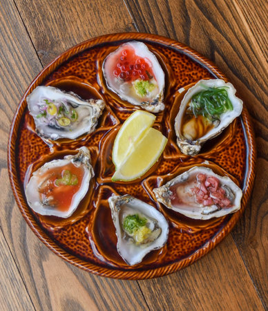 Six oysters with various toppings served on a brown ceramic plate