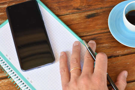 Outdoor telecommuting desk with a blue cup of coffeeの写真素材
