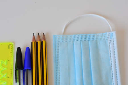 Schools supplies on white background in pandemic timeの写真素材