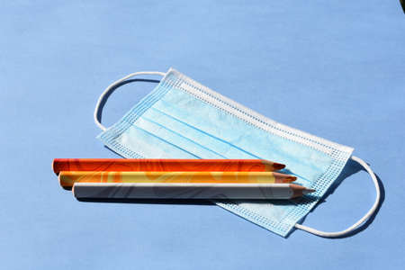 Back to school in pandemic time on blue backgroundの写真素材