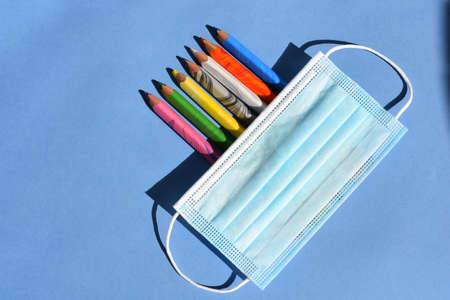 Back to school in pandemic time on blue backgroundの写真素材