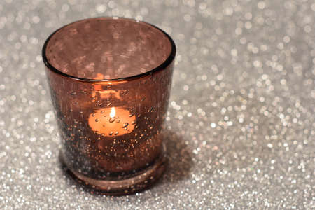 Christmas candle on silver backgroundの写真素材
