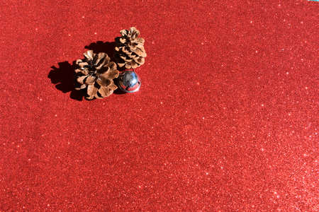 Brown pine pineapples over red background, Christmas time, Christmas decorationの写真素材