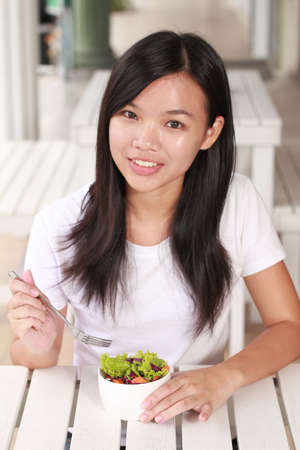 lady eat vegetable salad on the restaurantの写真素材