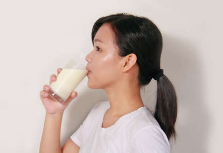 young lady drinking a glass of milkの写真素材