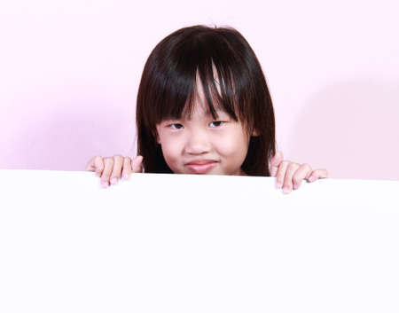 A little girl with a blank white boardの写真素材