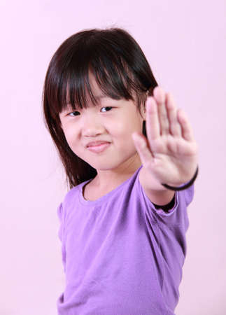 A little girl holds out her hand to stopの写真素材