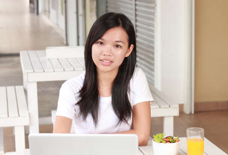 young business woman working on laptop at cafeの写真素材