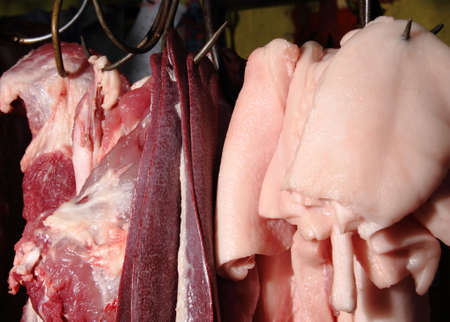 Fresh and bloody raw pork on market for sellの写真素材