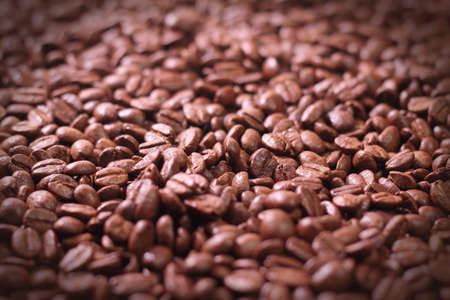 Brown coffee beans, close-up of coffee beans for background and texture 