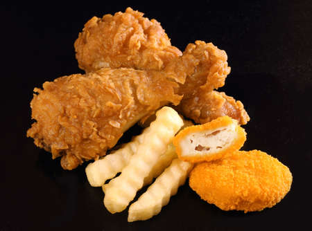 Fried chicken, nugget and french fries on black color backgroundの写真素材