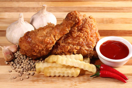 Hot and crispy fried chicken, french fries, chili, garlic and black pepperの写真素材