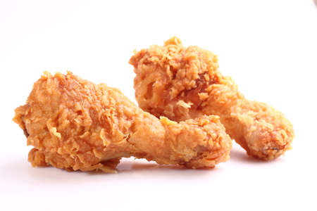 Two hot and crispy fried chicken legs on a white backgroundの写真素材
