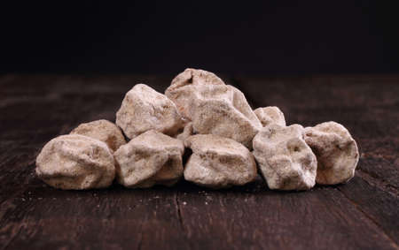Dried salted Chinese plum isolated on dark brown wooden backgroundの写真素材