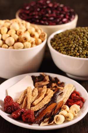 Traditional chinese dried herbal medicine on brown color wooden backgroundの写真素材