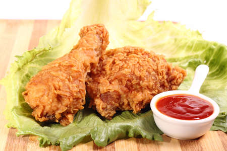 Hot and crispy fried chicken legs with chili and vegetableの写真素材