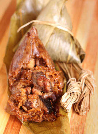 Two traditional homemade Chinese rice dumplings on wooden tableの写真素材