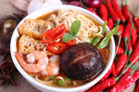 Hot and spicy instant noodle and ingredients on the tableの写真素材