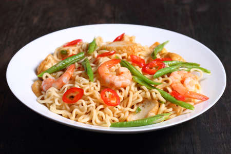 Hot and spicy fried noodle isolated on the dark color backgroundの写真素材
