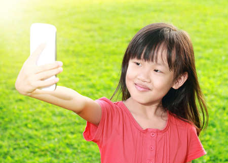 A girl playing smartphoneの写真素材