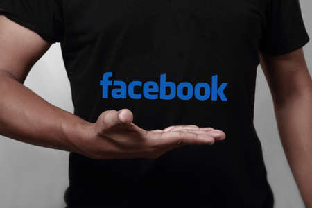 Johor, Malaysia - May 11, 2014: Hand showing facebook icon. Facebook is a largest social networking website in the world, May 11, 2014 in Johor, Malaysia.のeditorial素材