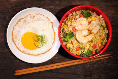 Homemade healthy fried rice and egg on brown backgroundの写真素材