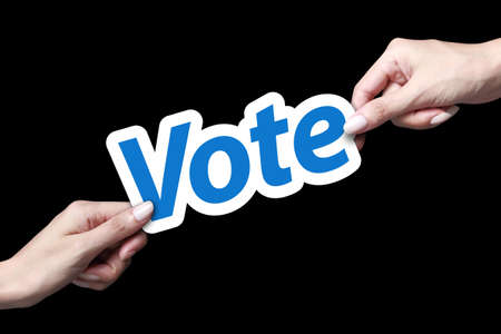 Hand holding blue color vote cardの写真素材