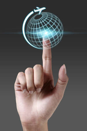 Hand pressing global icon on a virtual screenの写真素材