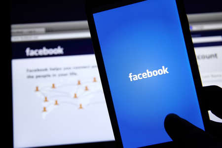 Johor, Malaysia - May 06, 2014: Facebook application on smart phone and notebook screen. Facebook is the worldâs largest social network, May 06, 2014 in Johor, Malaysia.のeditorial素材