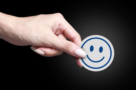 Card with happy icon in handの写真素材