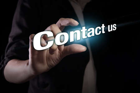 Hand showing contact us text on the virtual screenの写真素材