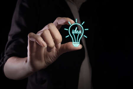 Hand showing idea icon on the virtual screenの写真素材