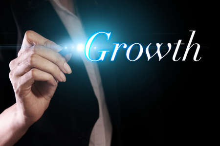 Hand writing Growth on virtual screenの写真素材