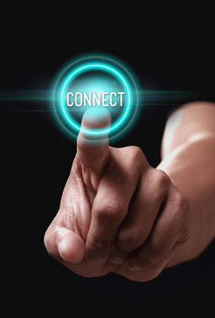 Hand pressing connect button on a virtual screenの写真素材