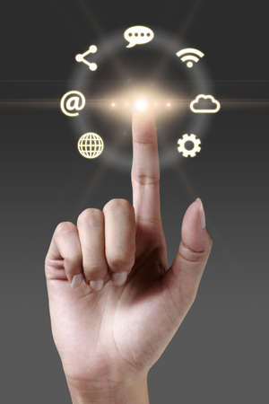 Hand pressing network icon on a virtual screenの写真素材