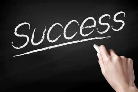 Hand writing Success with white chalkの写真素材