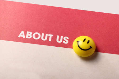 About us and smiley icon isolated on brown backgroundの写真素材