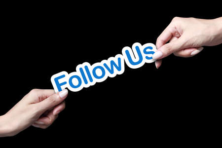 Hand giving follow us icon to another personの写真素材