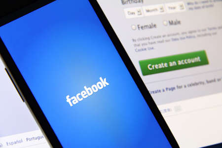 Johor, Malaysia - May 06, 2014: Facebook page on smart phone and notebook screen. Facebook is the worlds largest social network, May 06, 2014 in Johor, Malaysia.のeditorial素材