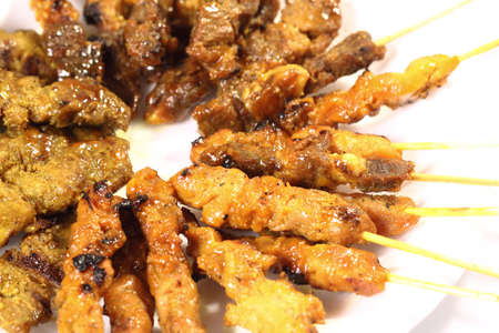 Satay is a Malaysian-style kebab. It is served with a peanut sauce, and slivers of cucumbers and onions.の写真素材