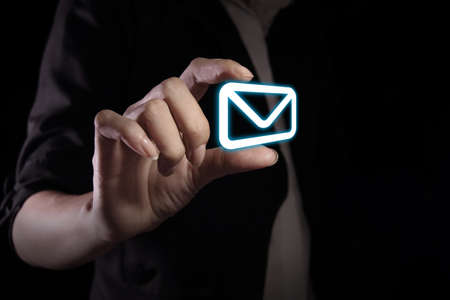 Hand showing message icon on the virtual screenの写真素材